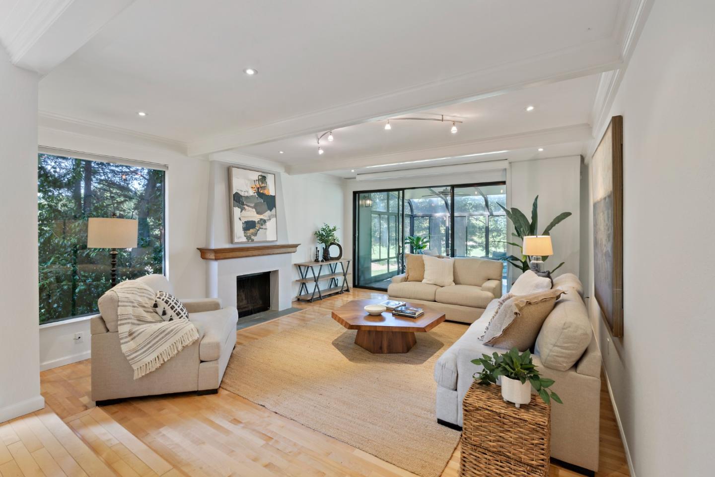 a living room with furniture fireplace and a large window