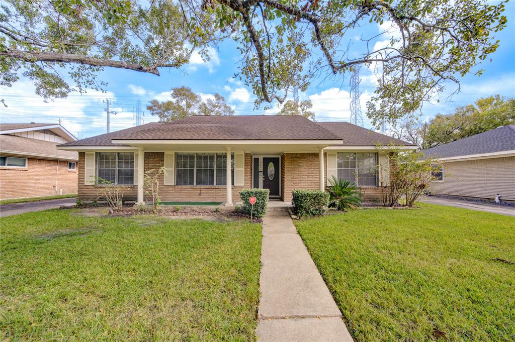 a front view of a house with yard patio and green space