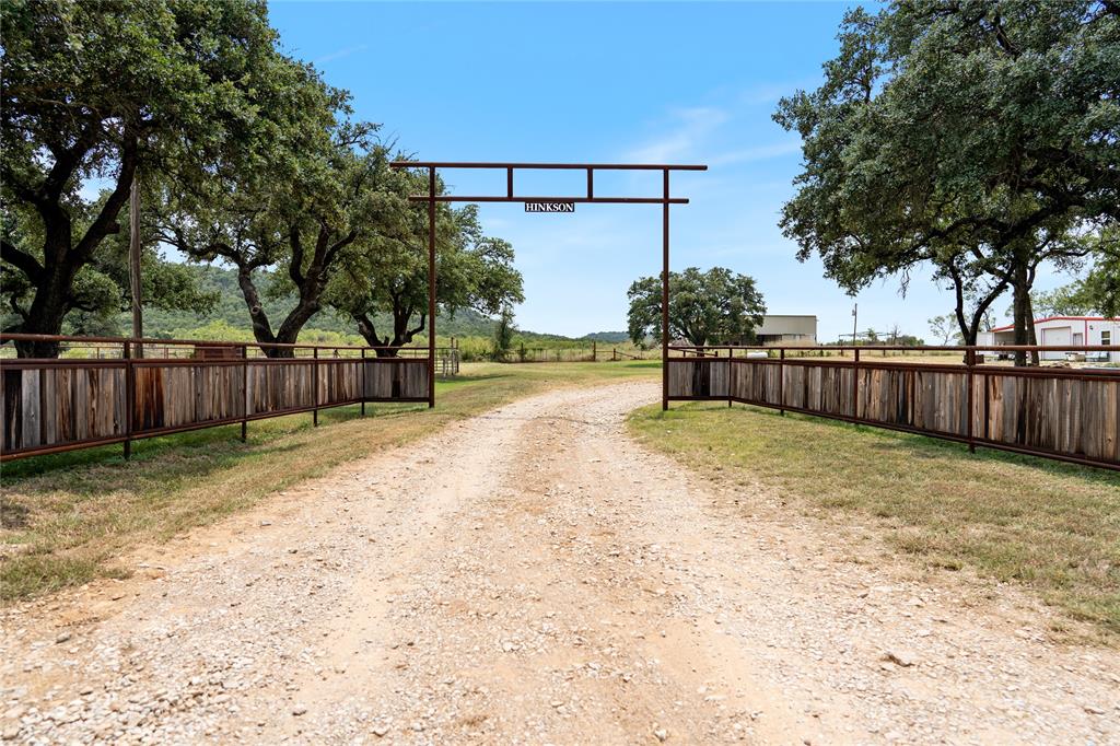 a view of a yard with wooden fence