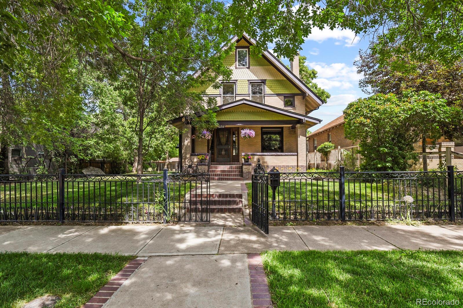 a front view of a house with a yard and fence