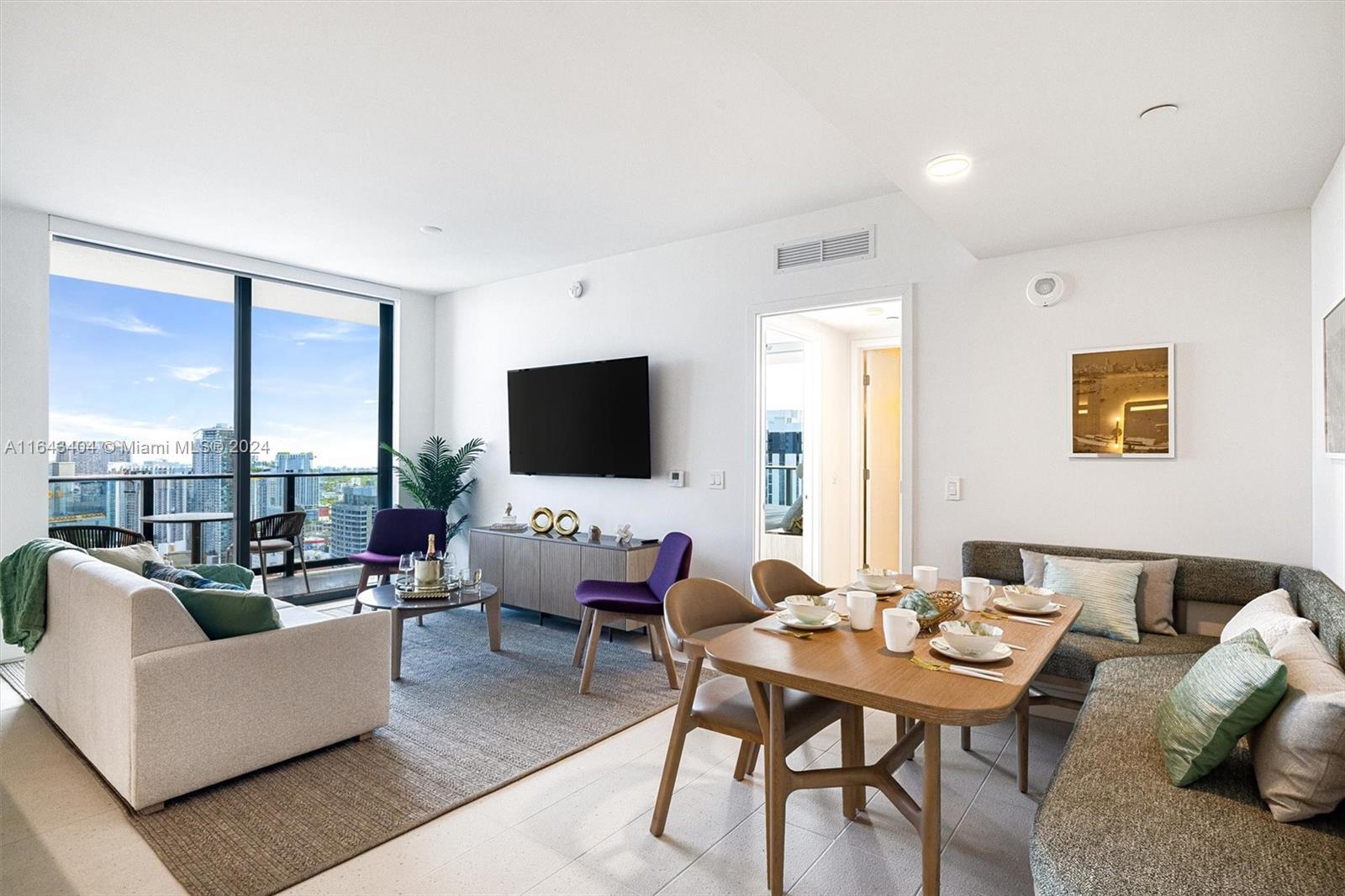 a living room with furniture floor and a flat screen tv