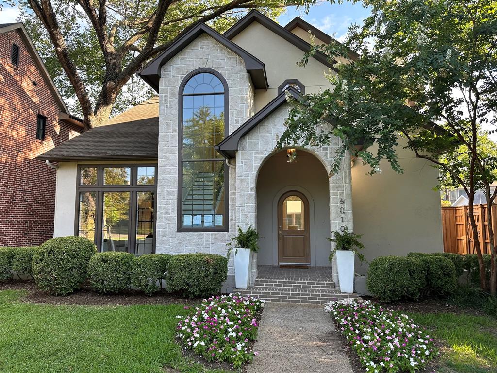 a front view of a house with a garden