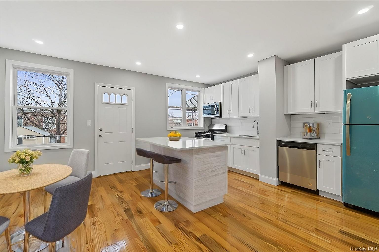 a kitchen with a sink cabinets and wooden floor