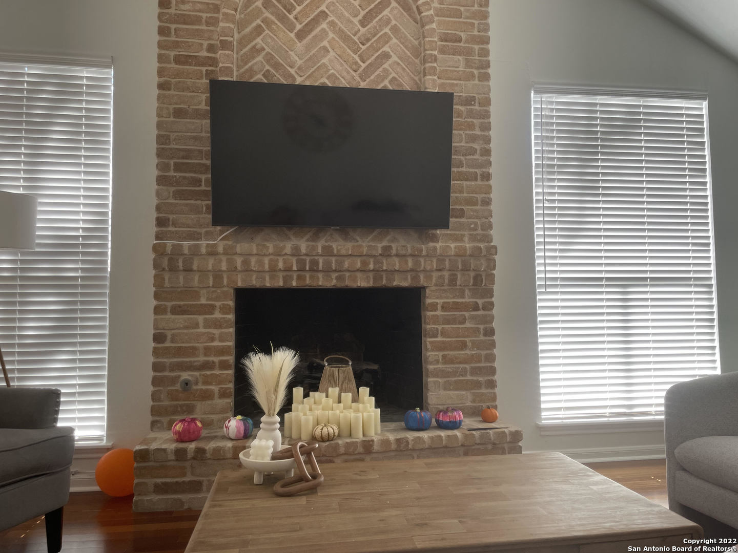 a living room with fireplace furniture and a flat screen tv