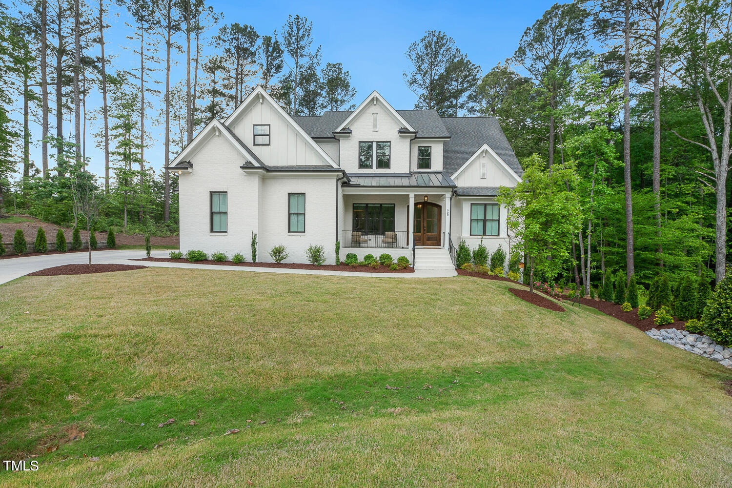 a front view of house with yard and green space