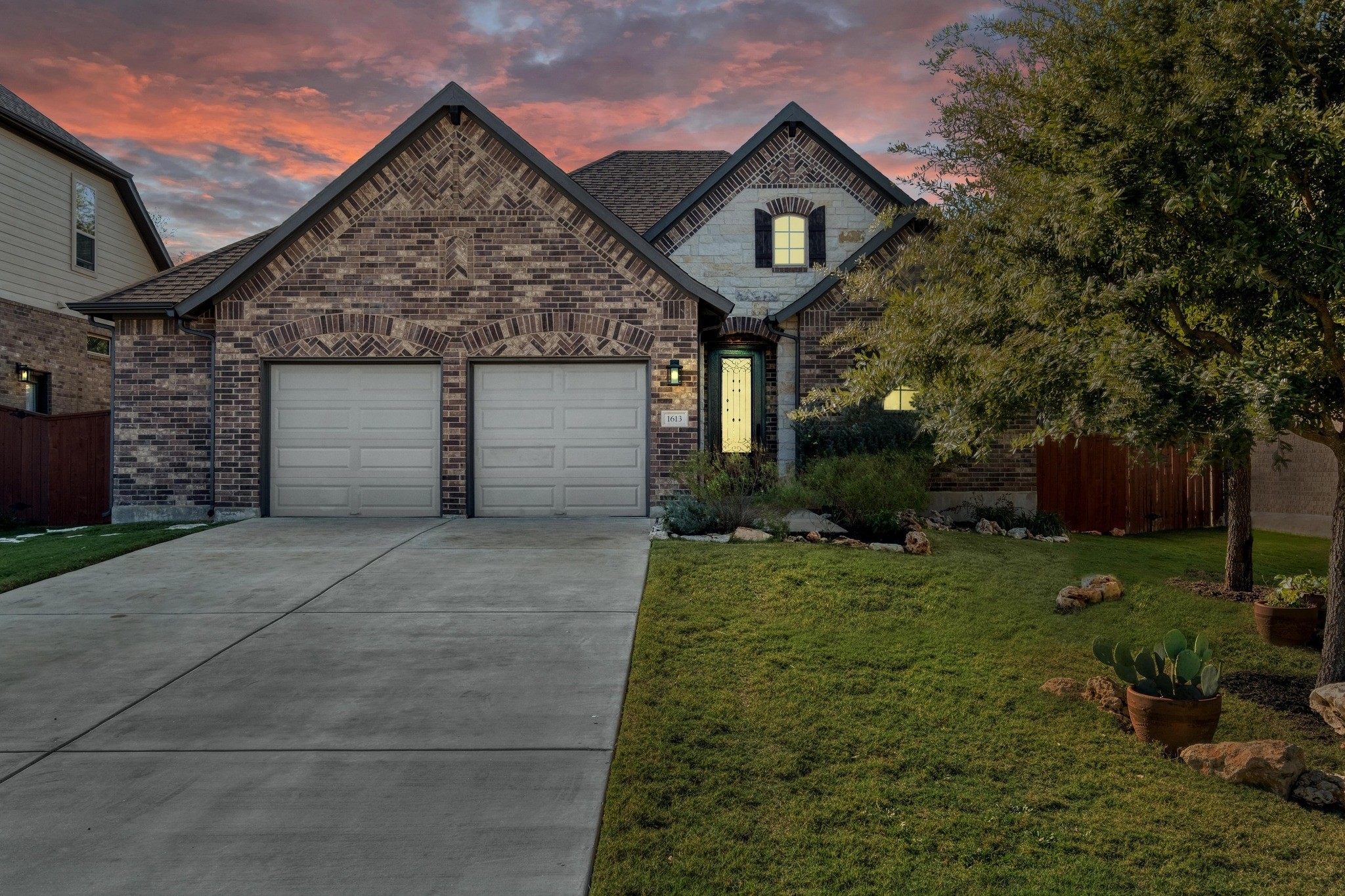 a front view of a house with a yard and garage