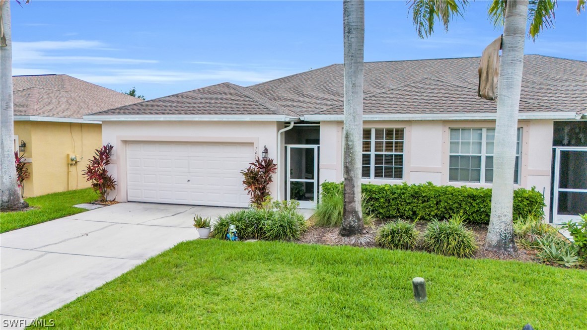 a front view of a house with a yard and garage