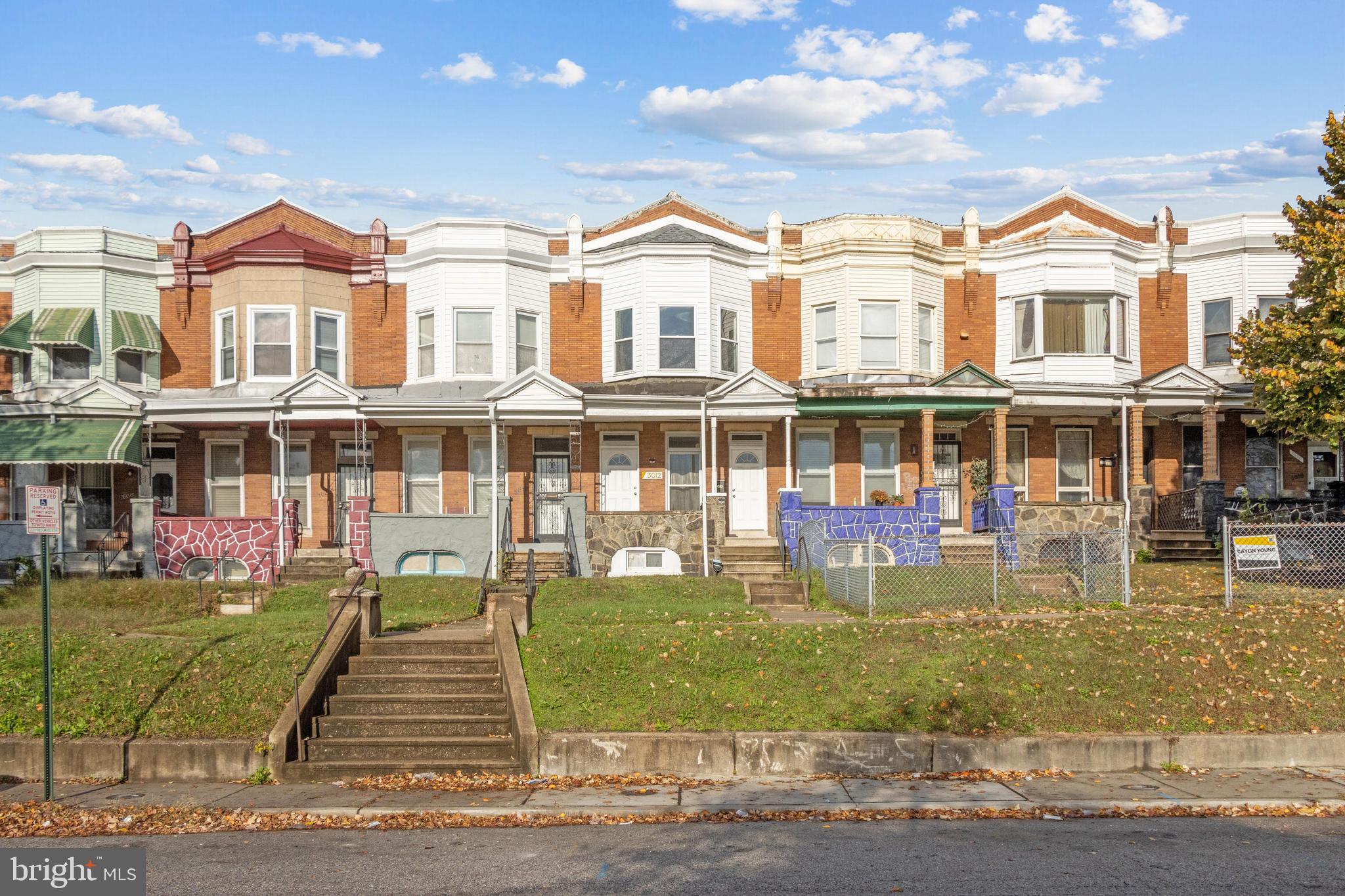 a front view of a residential apartment building with a yard