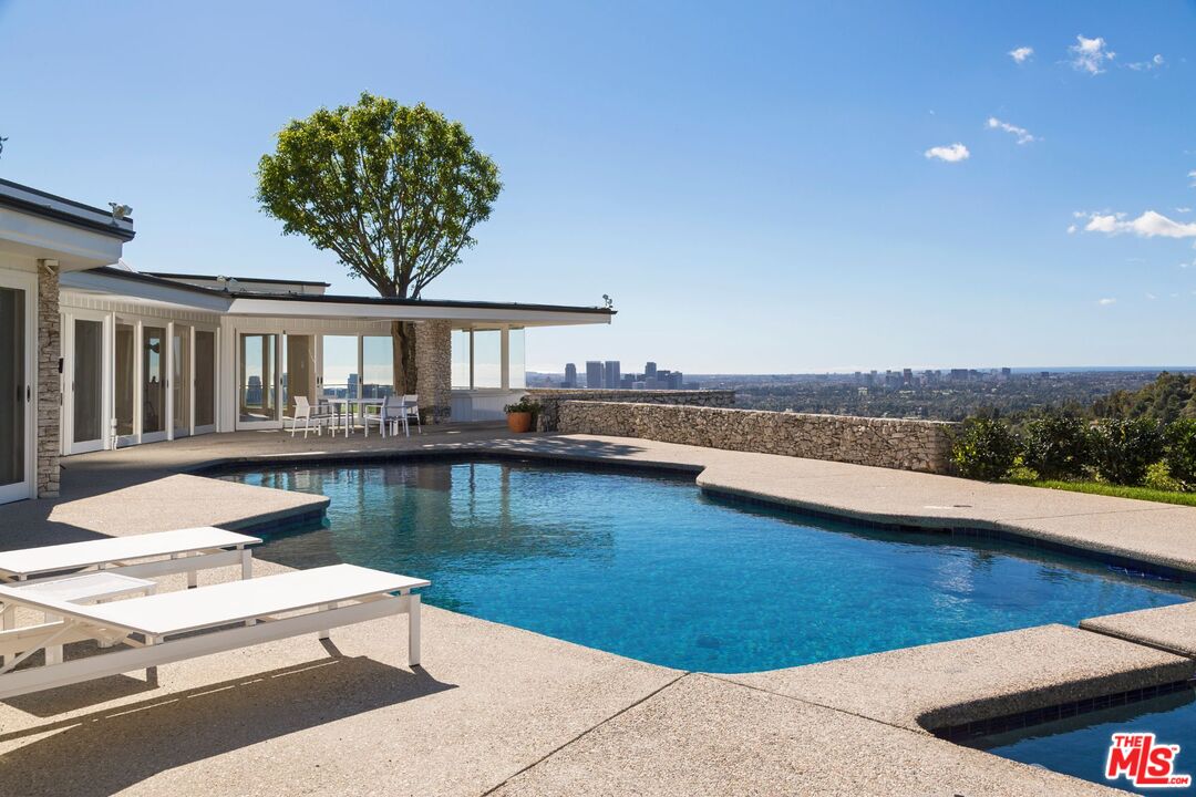 a view of a house with pool and lake view