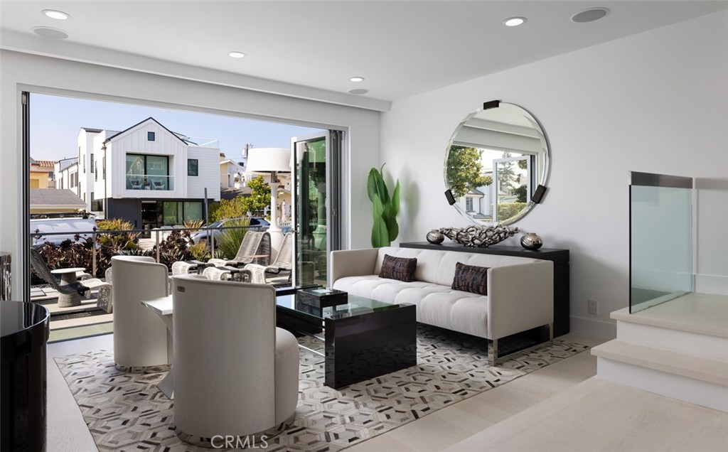 a living room with furniture a fireplace and a potted plant