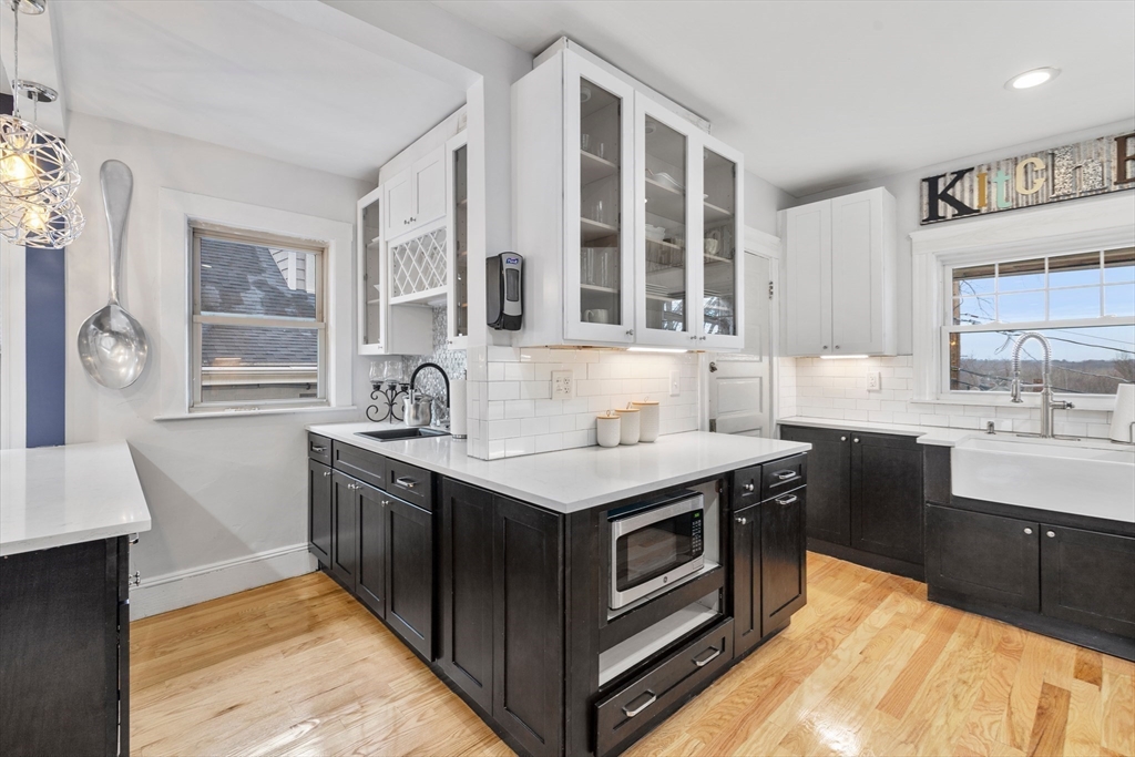 a kitchen with stainless steel appliances granite countertop a sink and a stove