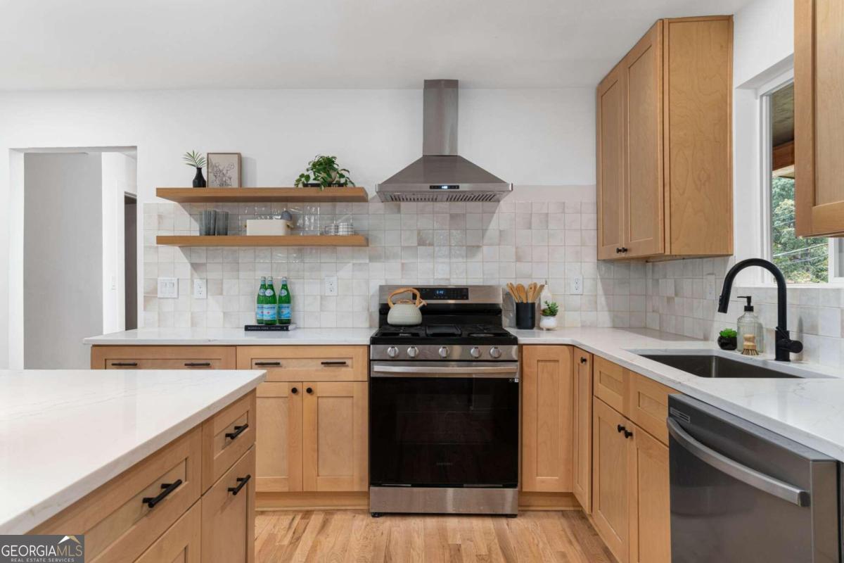 a kitchen with stainless steel appliances granite countertop a stove and a sink