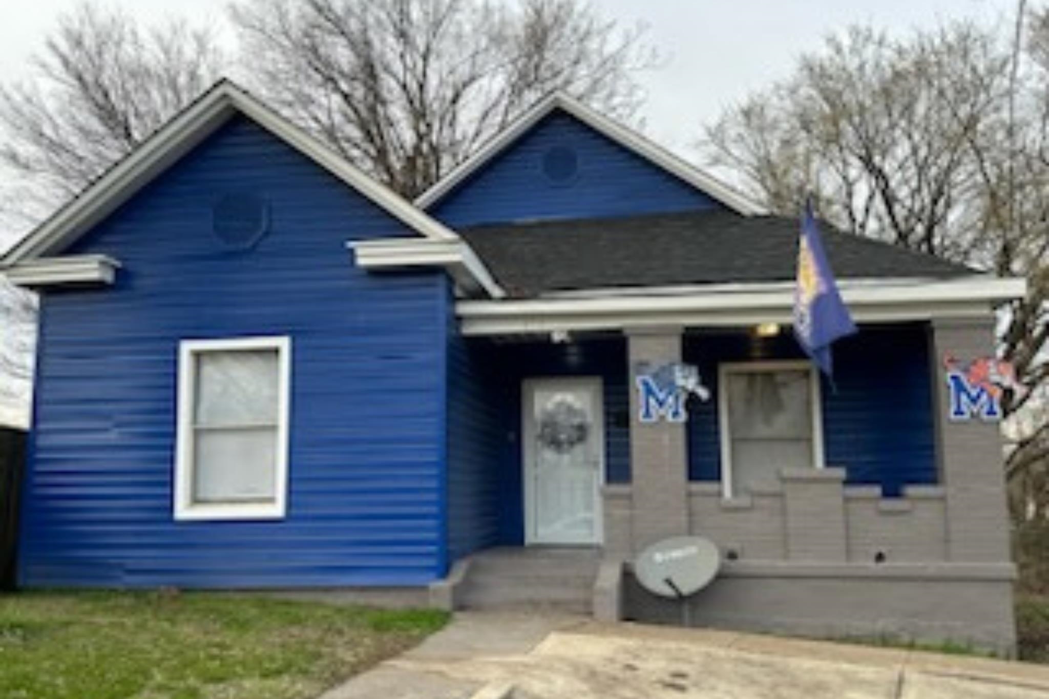 a front view of a house with garden