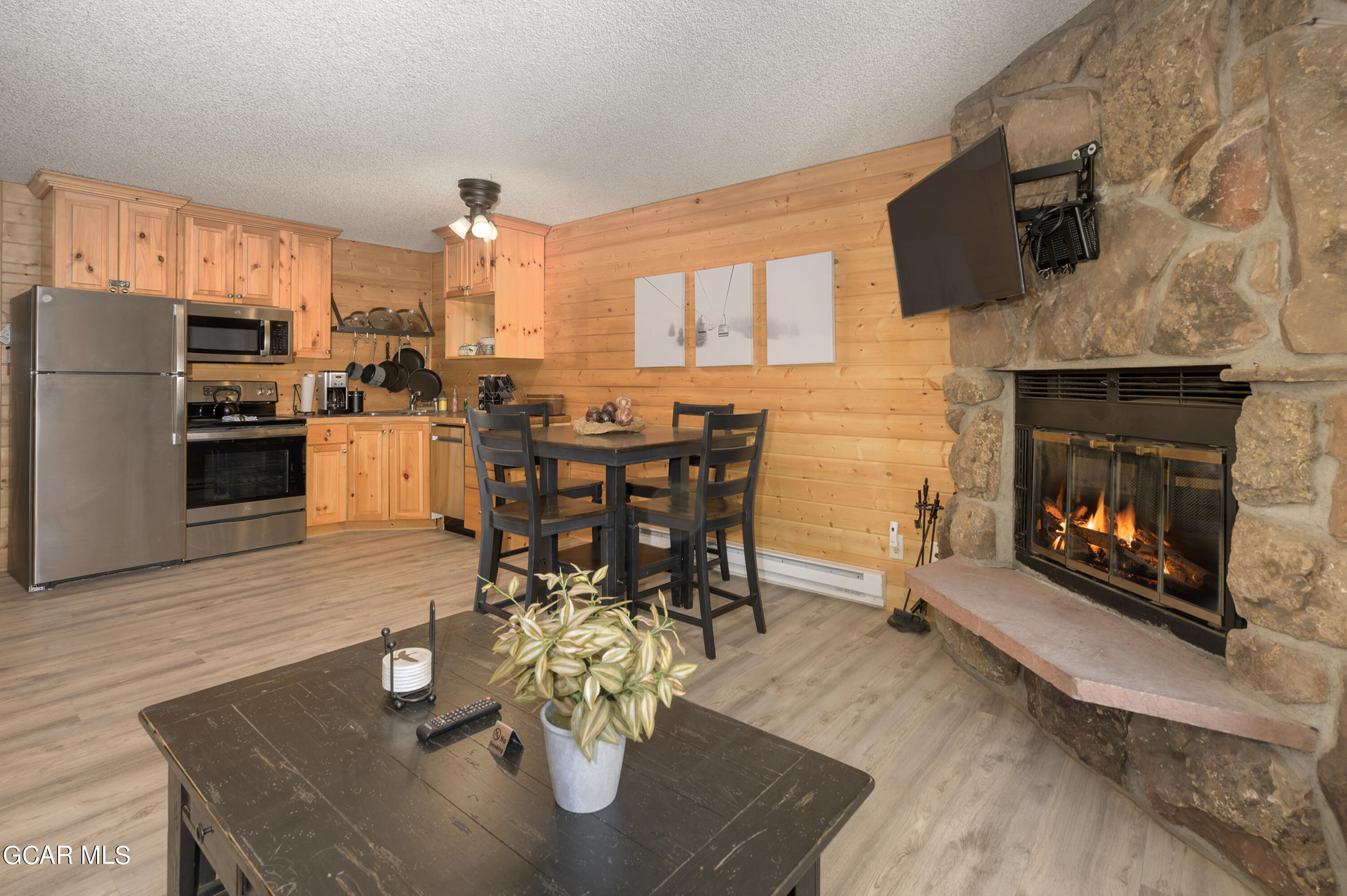 a living room with furniture a fireplace and a flat screen tv