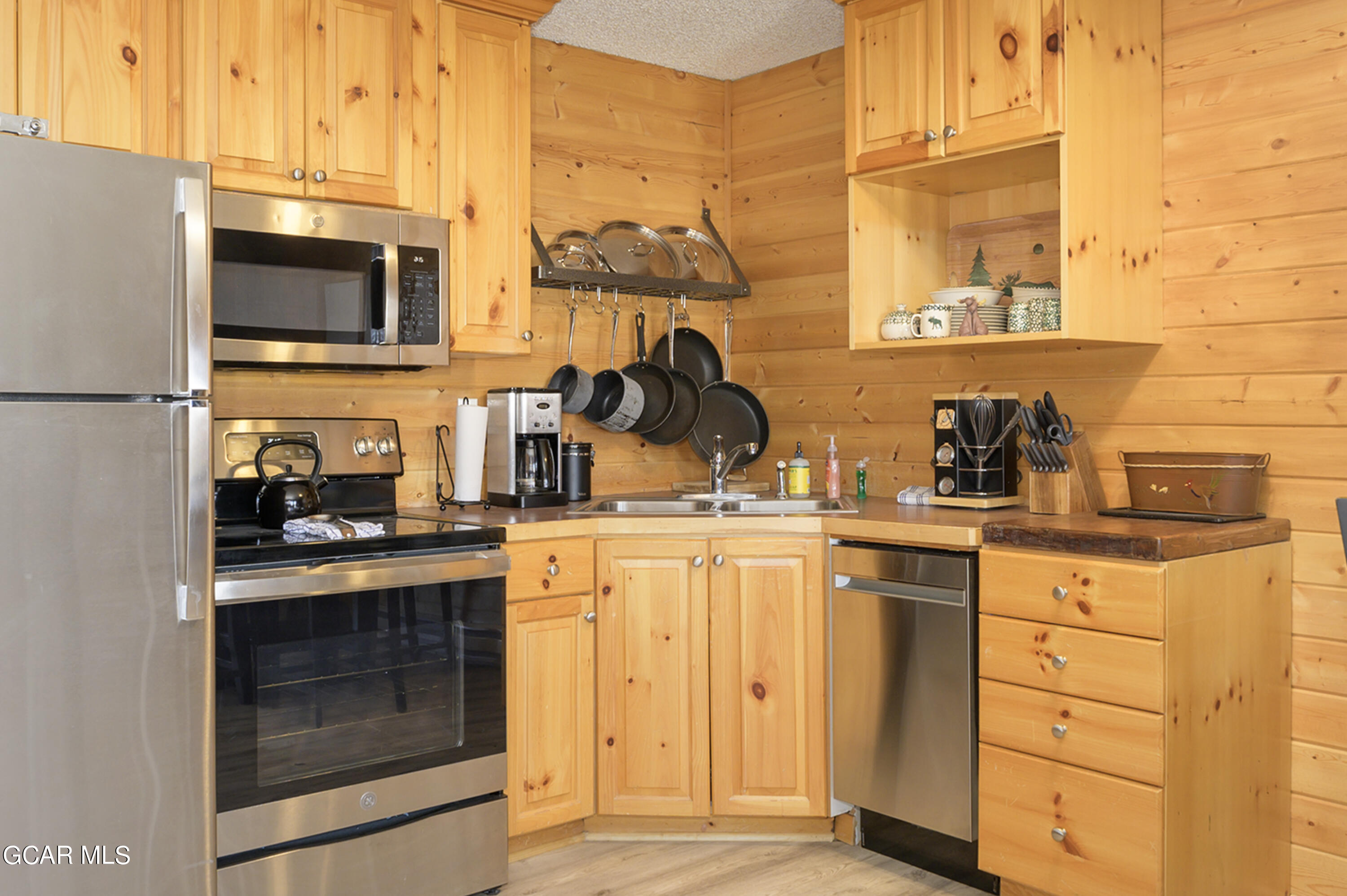 a kitchen with stainless steel appliances granite countertop a sink and a stove