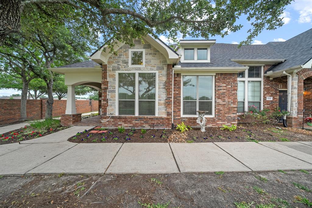 a front view of a house with a yard and a garage