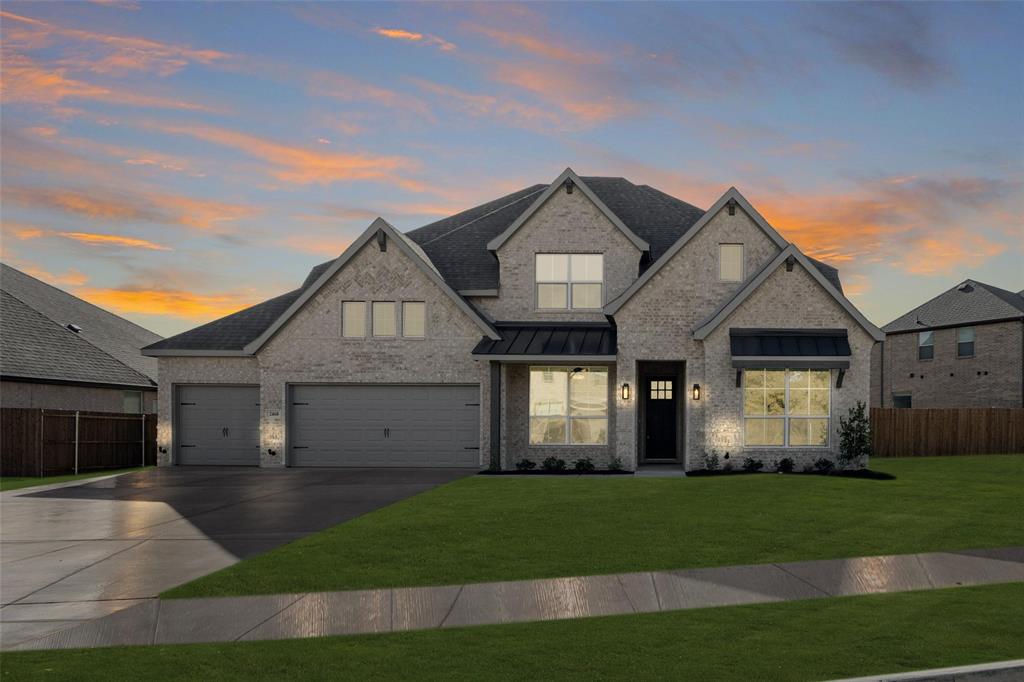 a front view of a house with a yard and garage