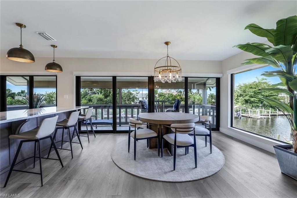 a view of a dining room with furniture wooden floor and chandelier