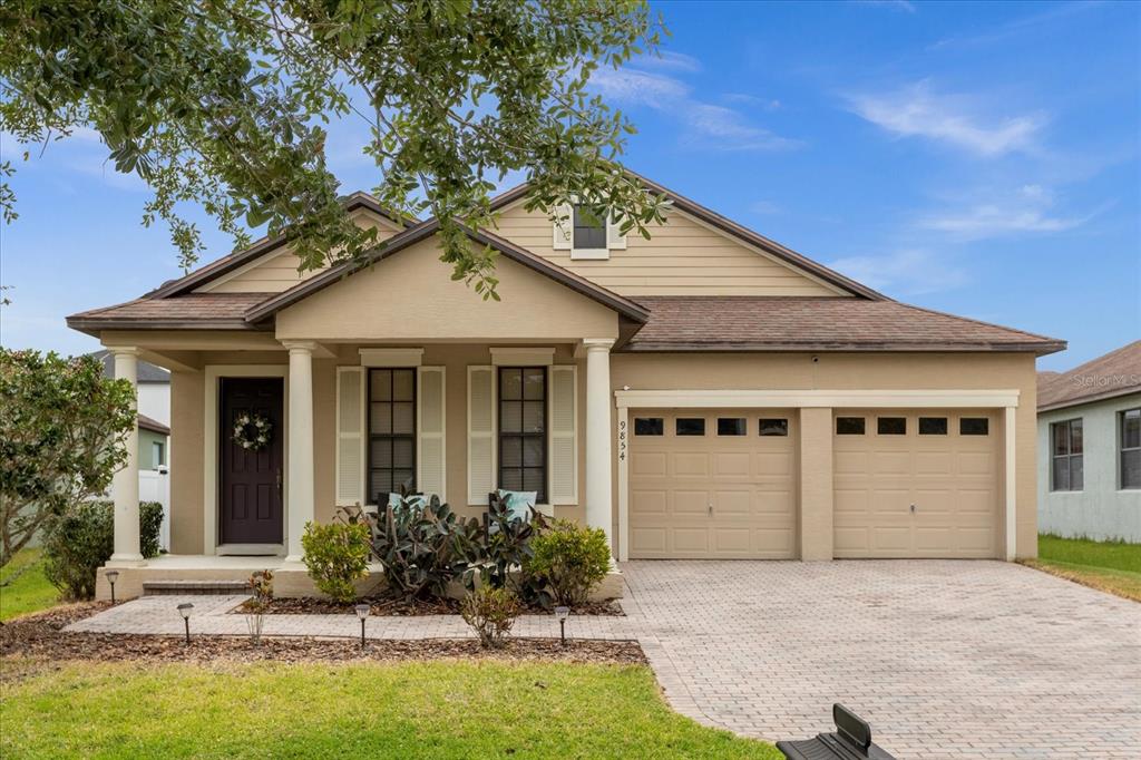 a front view of a house with a yard garage and outdoor seating