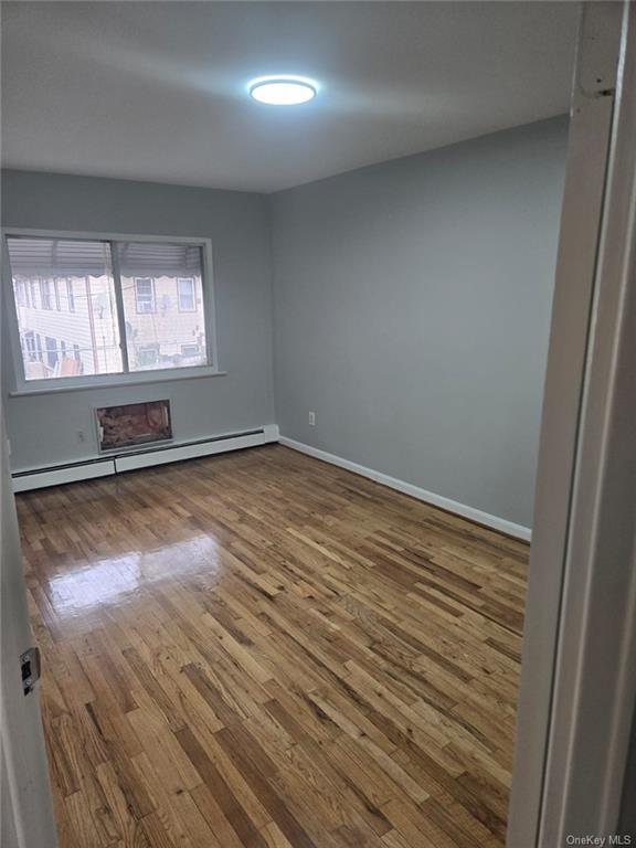 a room with wooden floor and window