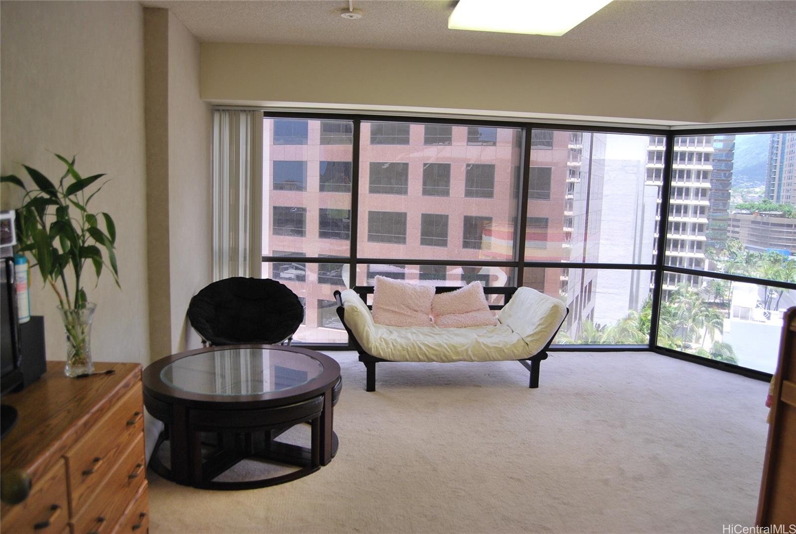 a living room with furniture and a potted plant