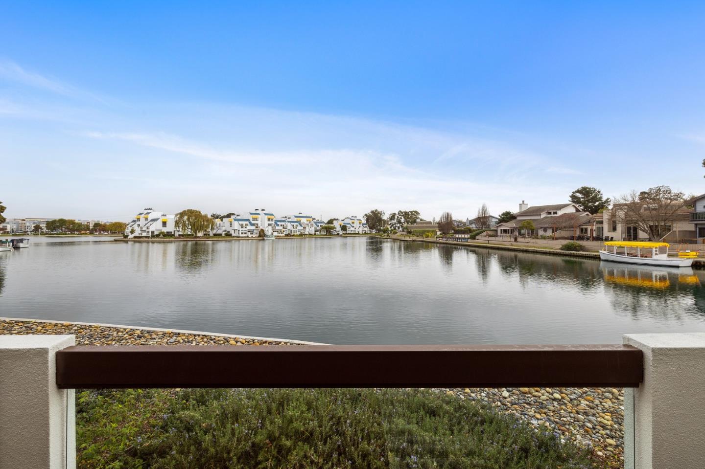 a view of a lake with houses in the background