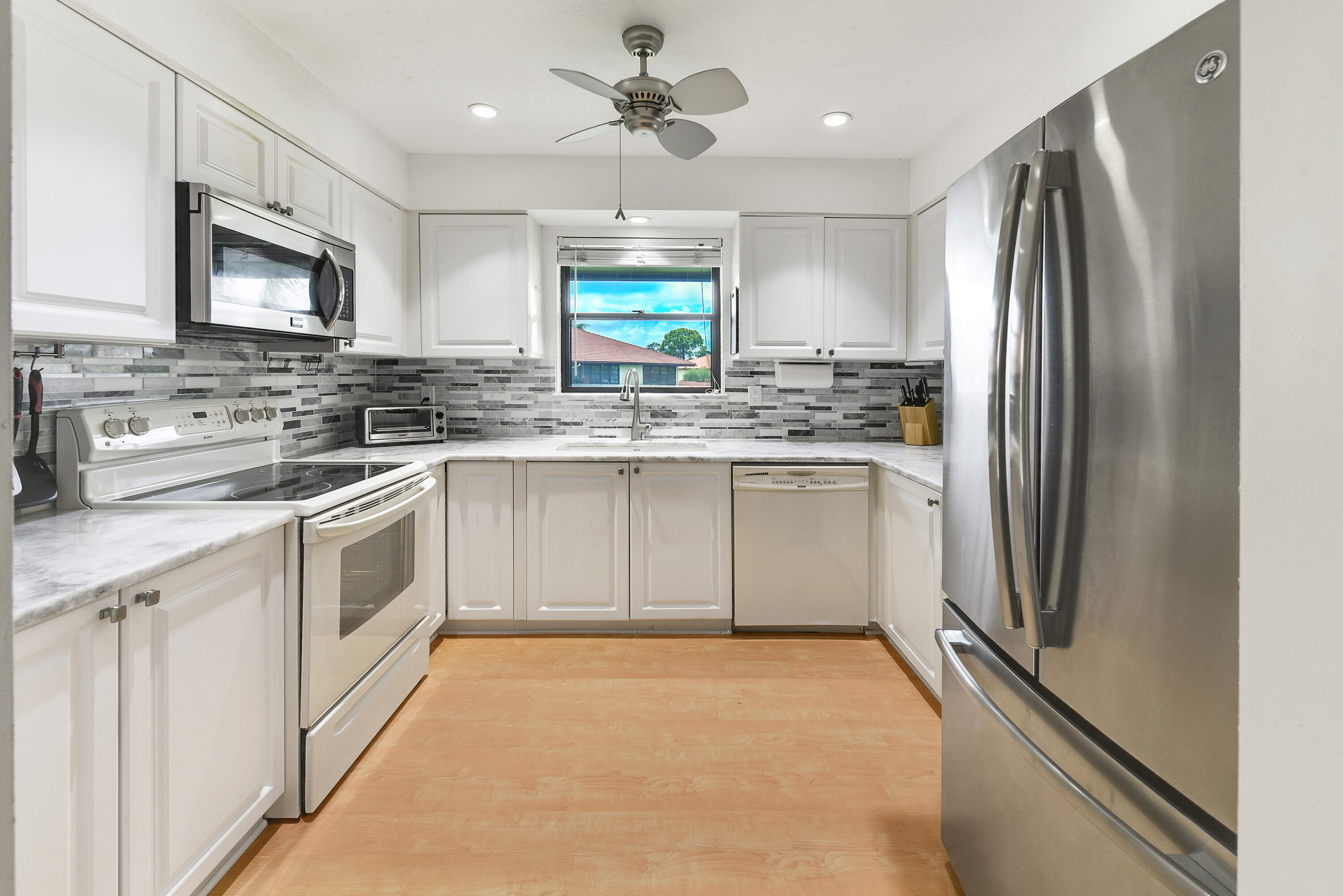 a kitchen with a sink stove and refrigerator