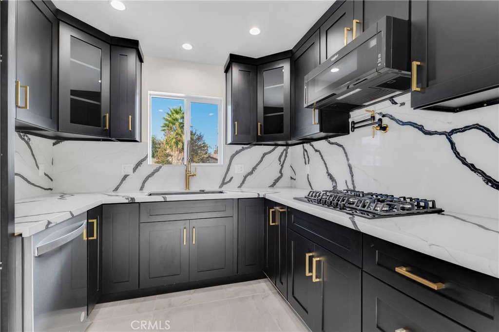 a kitchen with stainless steel appliances a sink and cabinets