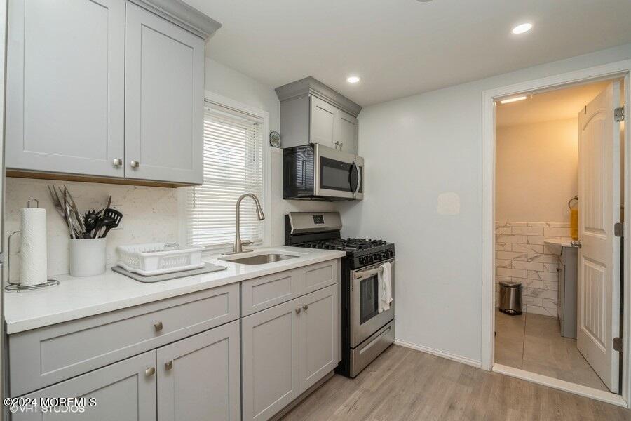 a kitchen with a sink stove and cabinets