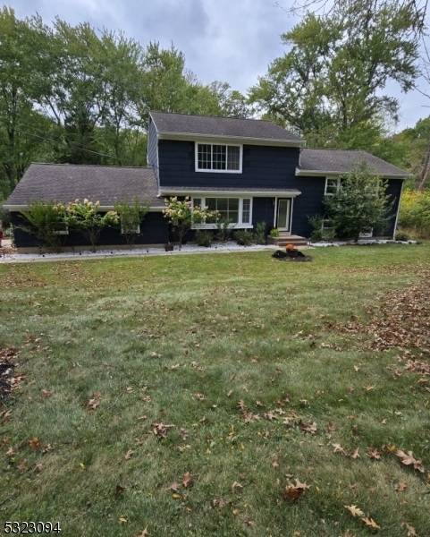 a view of a house with a yard balcony and sitting area