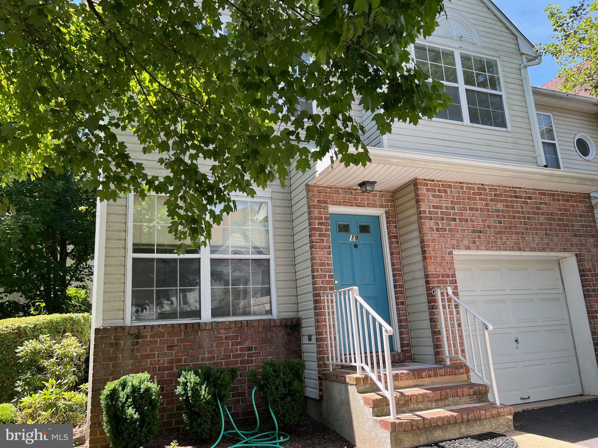 front view of a house with a tree