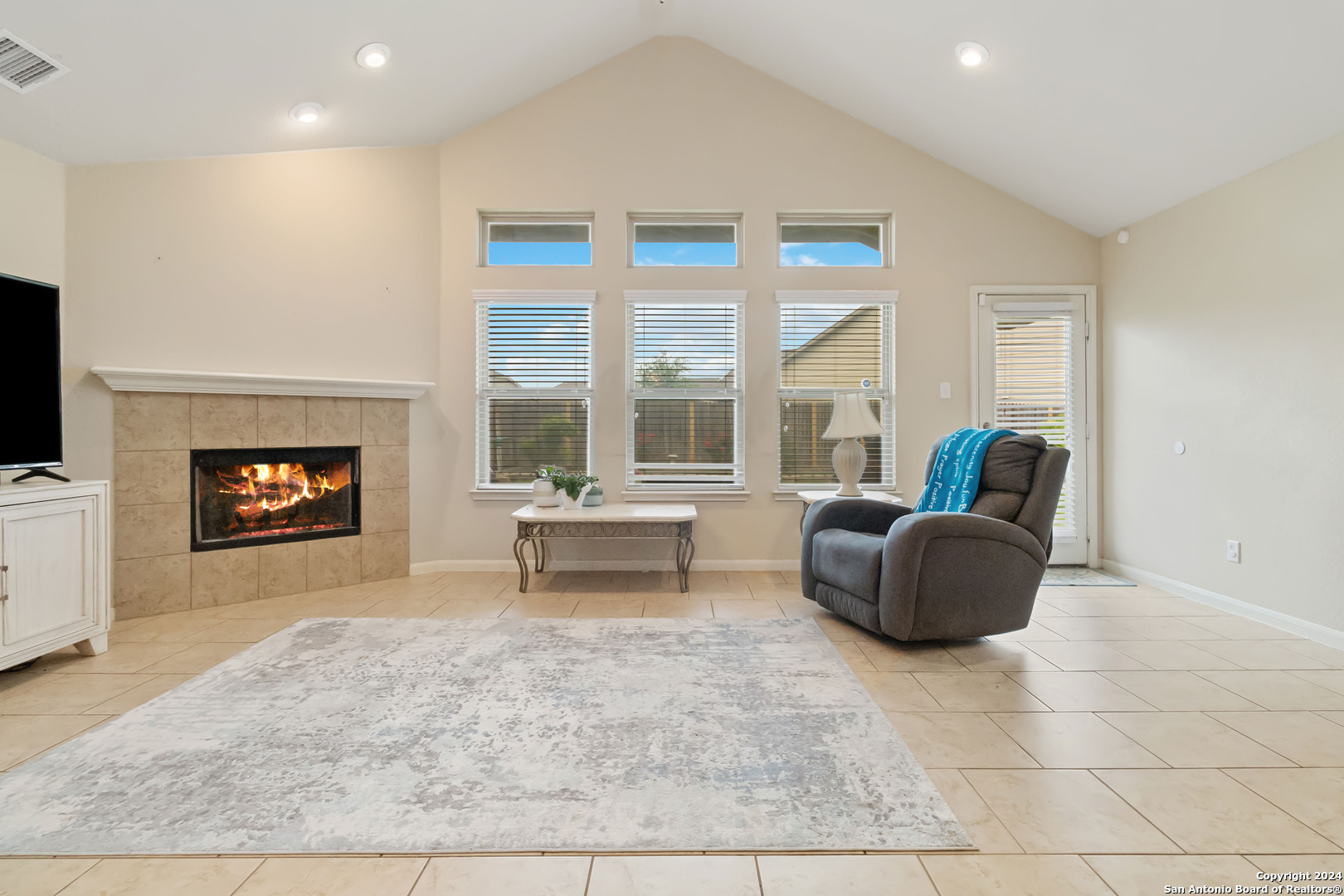 a living room with furniture and a fireplace