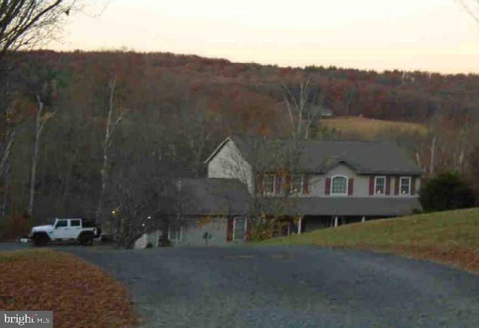 a view of a house with a mountain yard