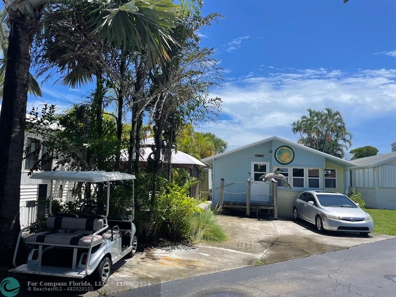 a view of a car park in front of a house