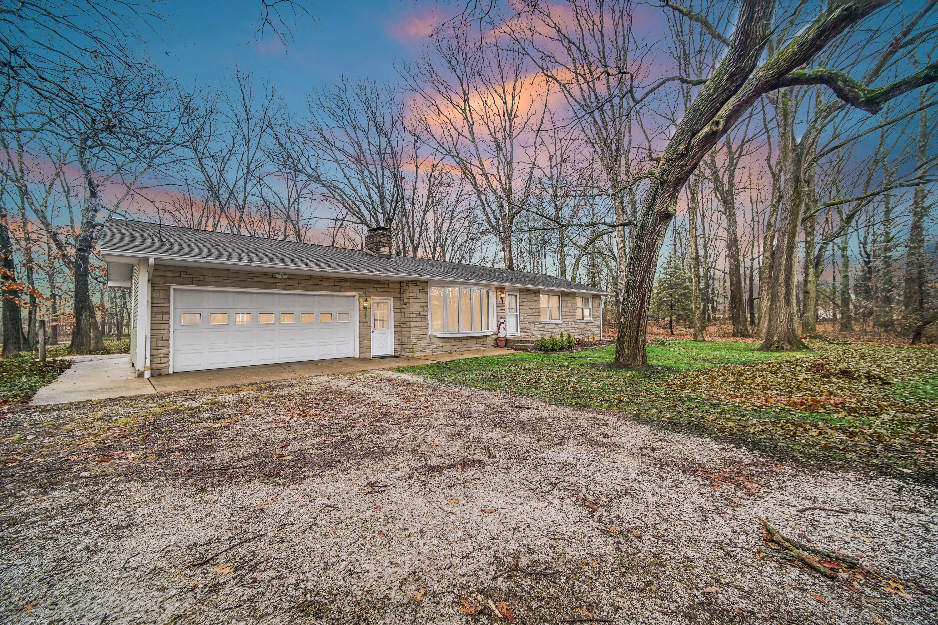 a view of a house with a yard and garage