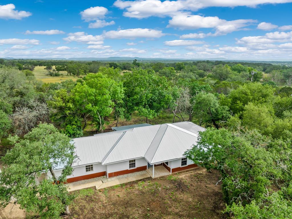 an aerial view of a house with a yard