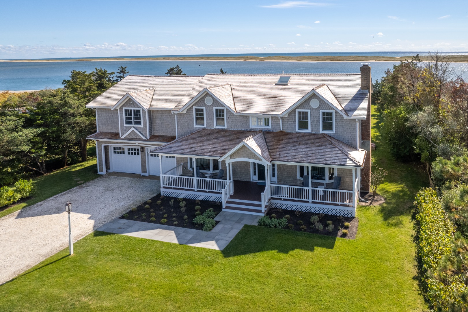 an aerial view of a house with swimming pool next to a yard