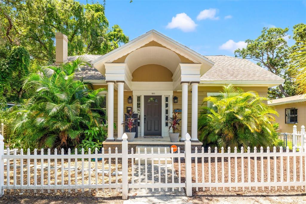 a front view of a house having a garden