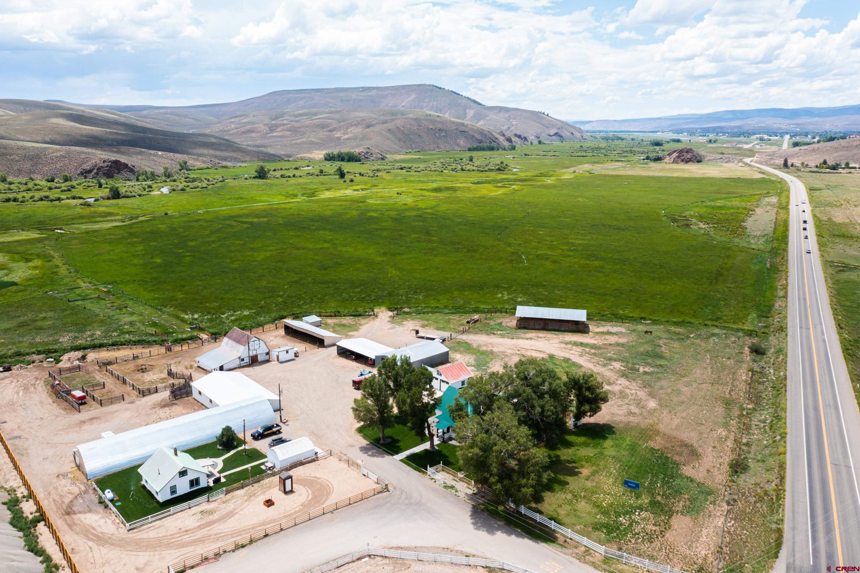 an aerial view of a houses with a yard