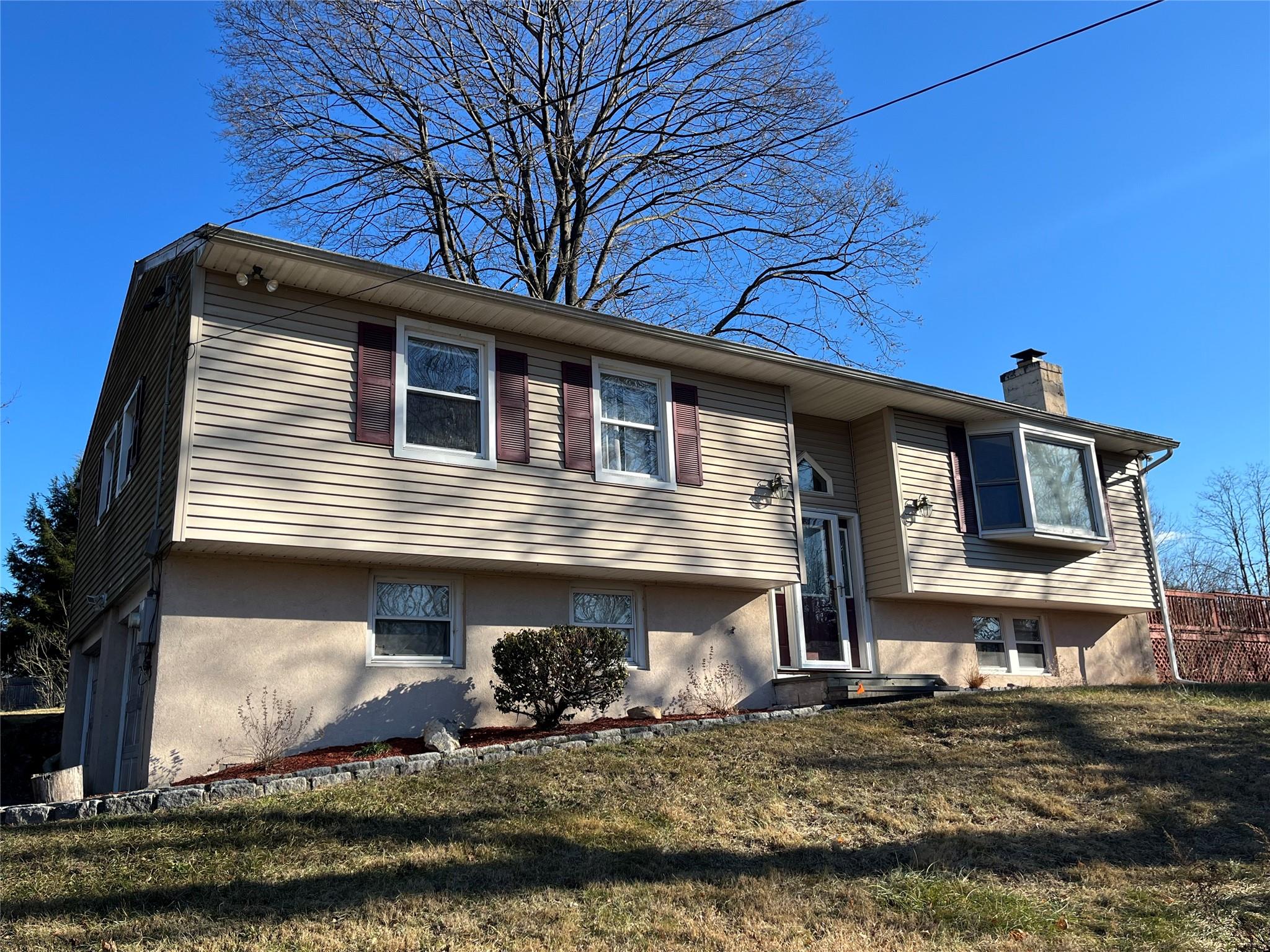 Bi-level home featuring a front lawn