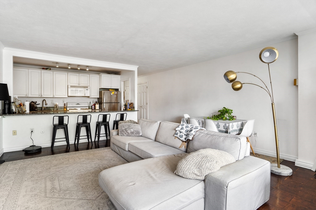 a living room with furniture and kitchen view