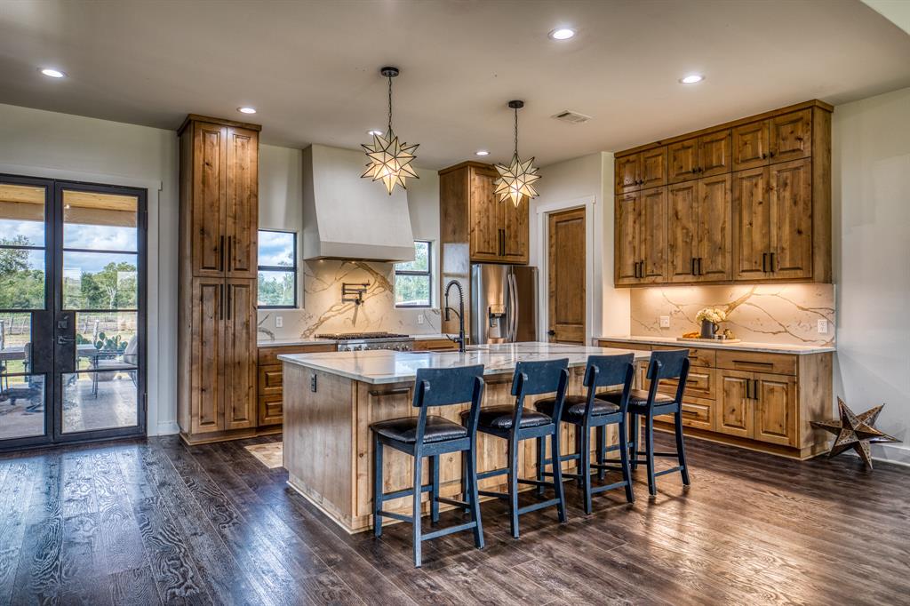 a large kitchen with a table and chairs in it