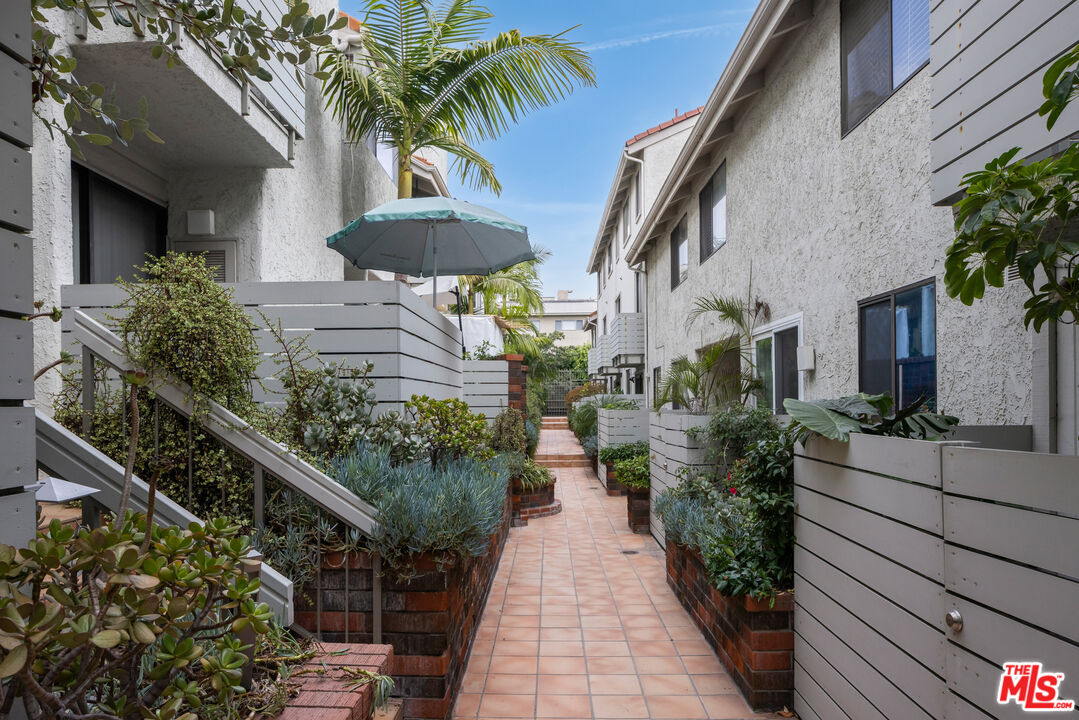 a view of a house with potted plants