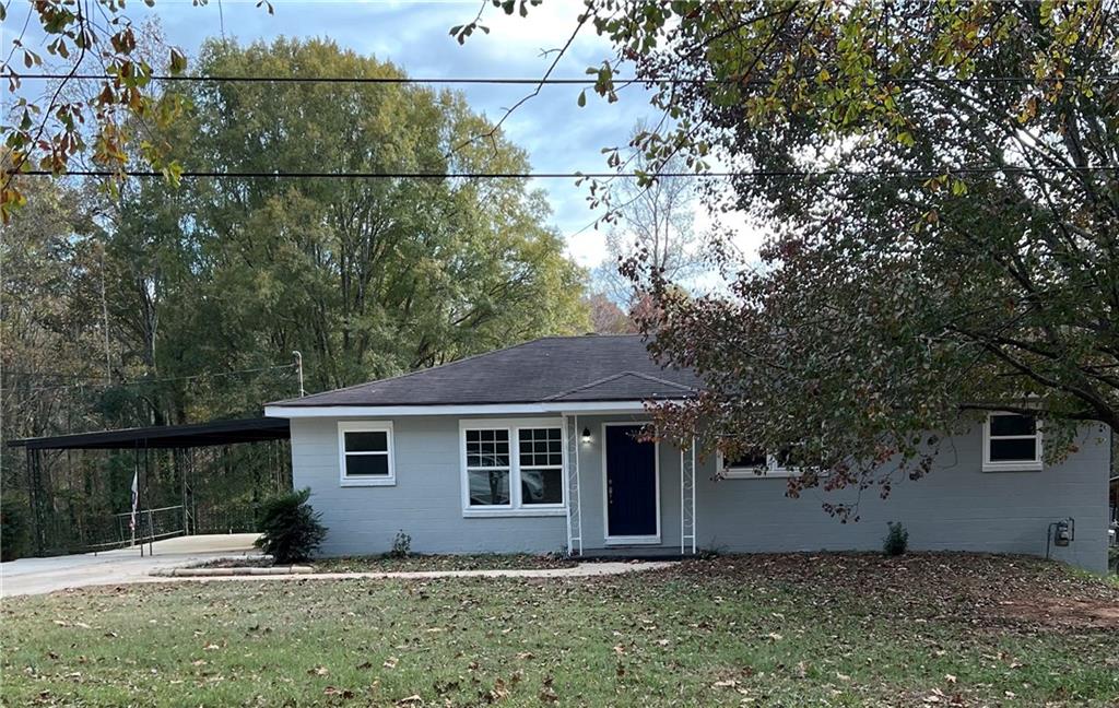 a view of front of house with a tree