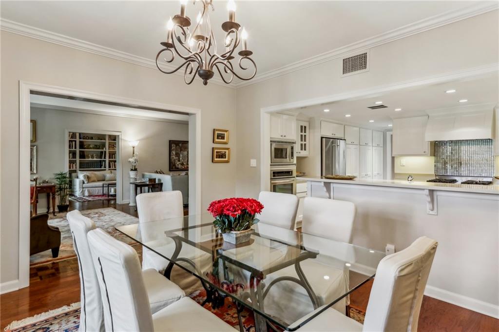 a view of a dining room with furniture and a chandelier