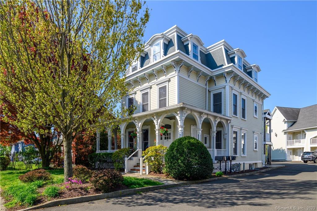 a front view of a building with a garden