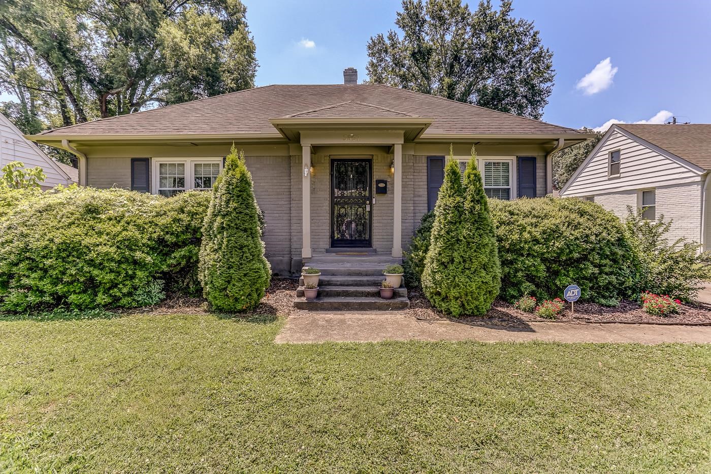 front view of a house with a yard