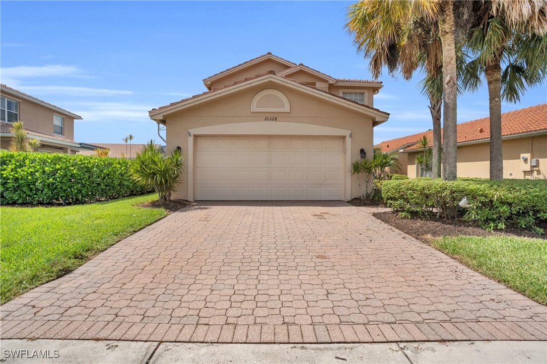 a front view of a house with a yard and garage