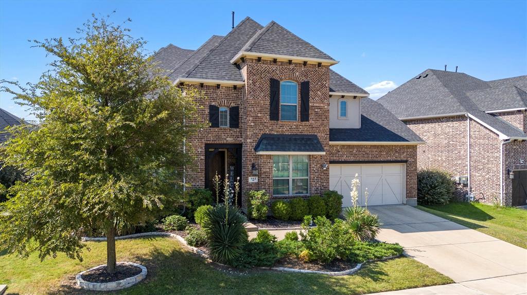 a front view of a house with a yard garage and outdoor seating