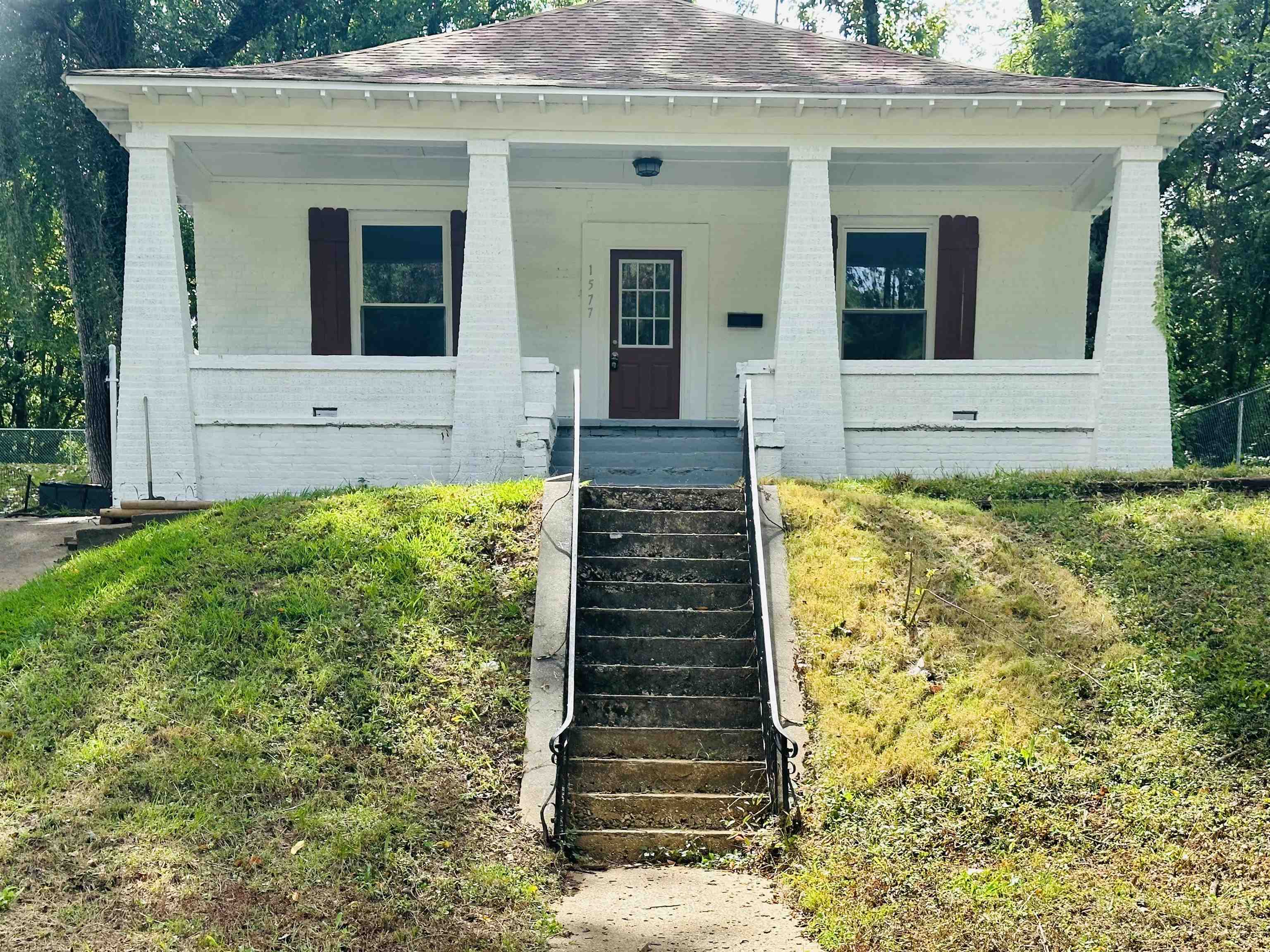 a front view of a house with garden